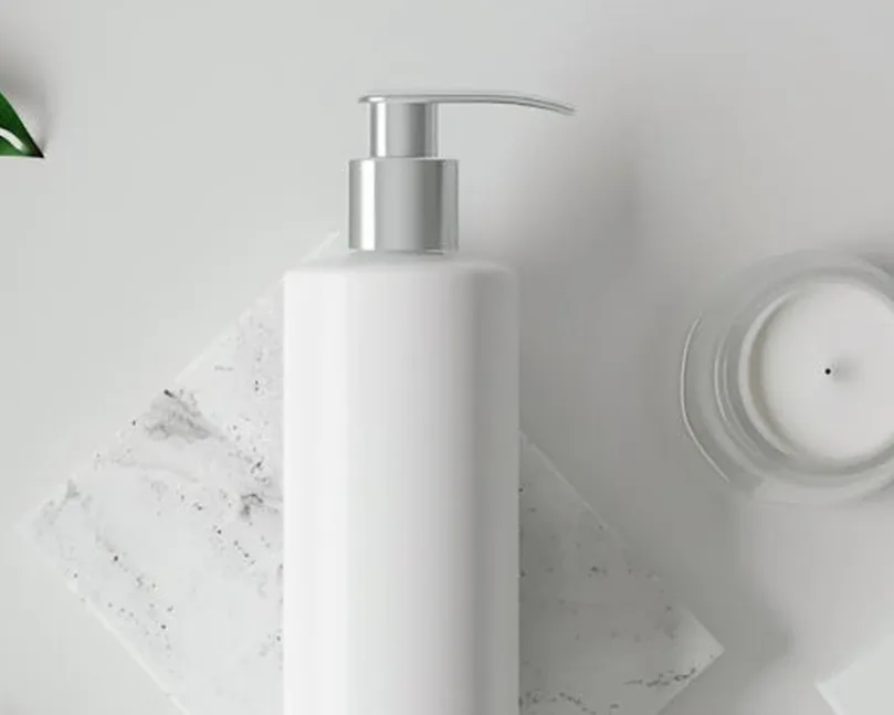 White pump bottle and jar on a light background