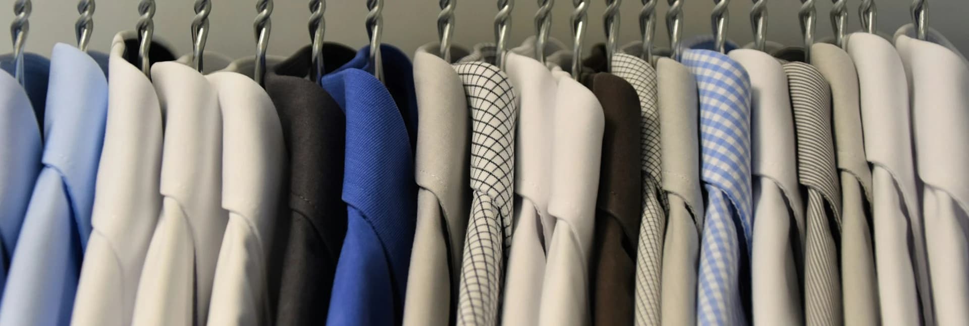 Shirts and jackets on a clothing rack