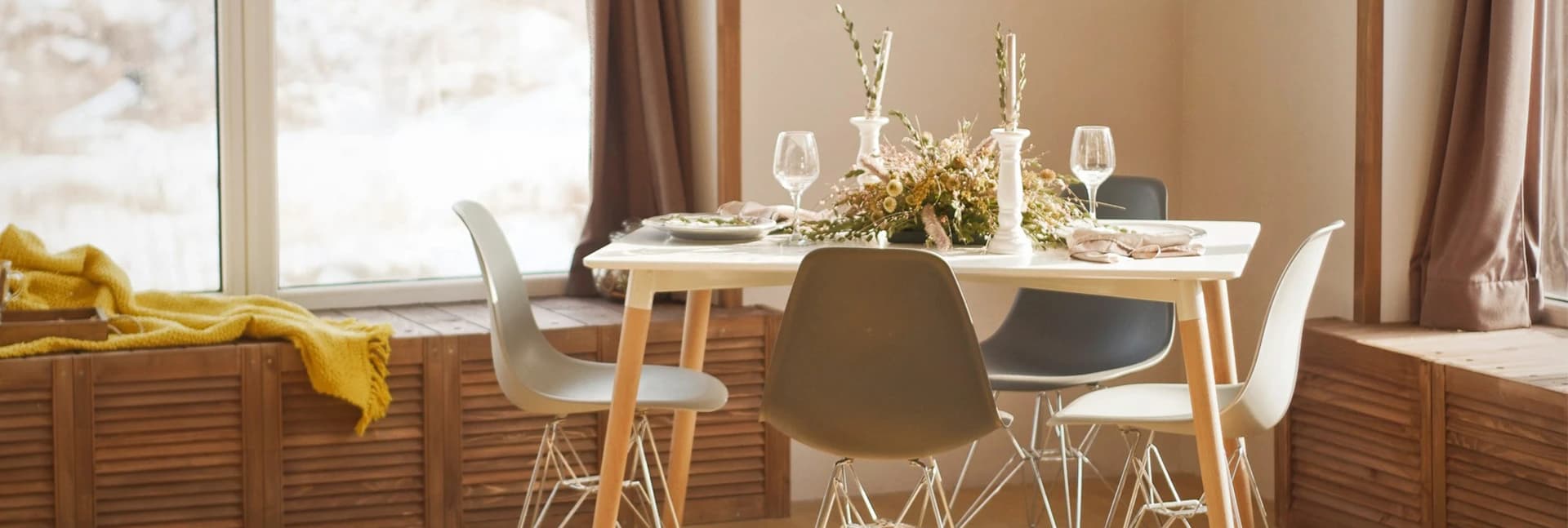 Dining table set with glassware and dried flowers